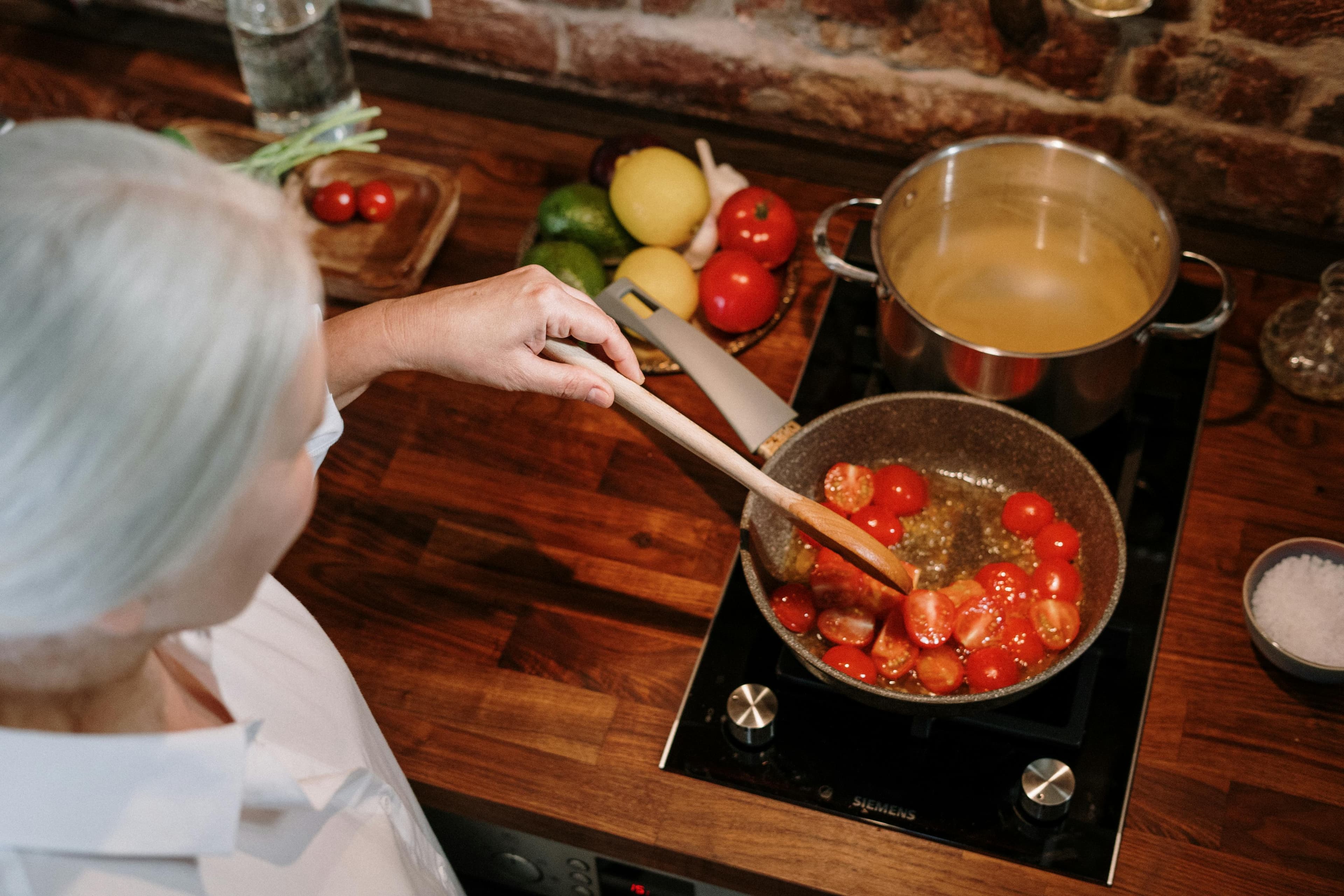 Woman cooking in a warm rustic kitchen