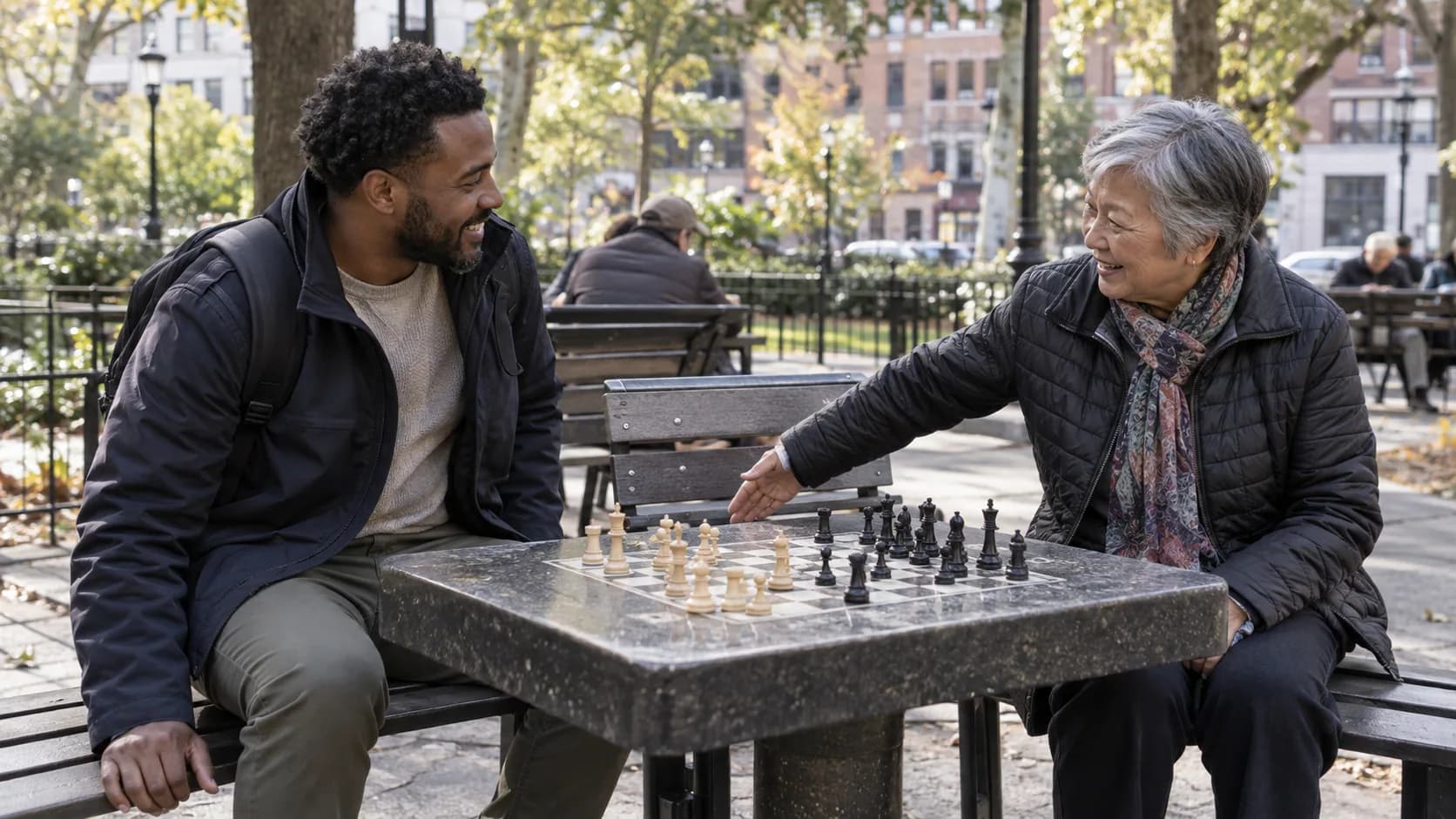 A newcomer joining an older player at a public chess table.