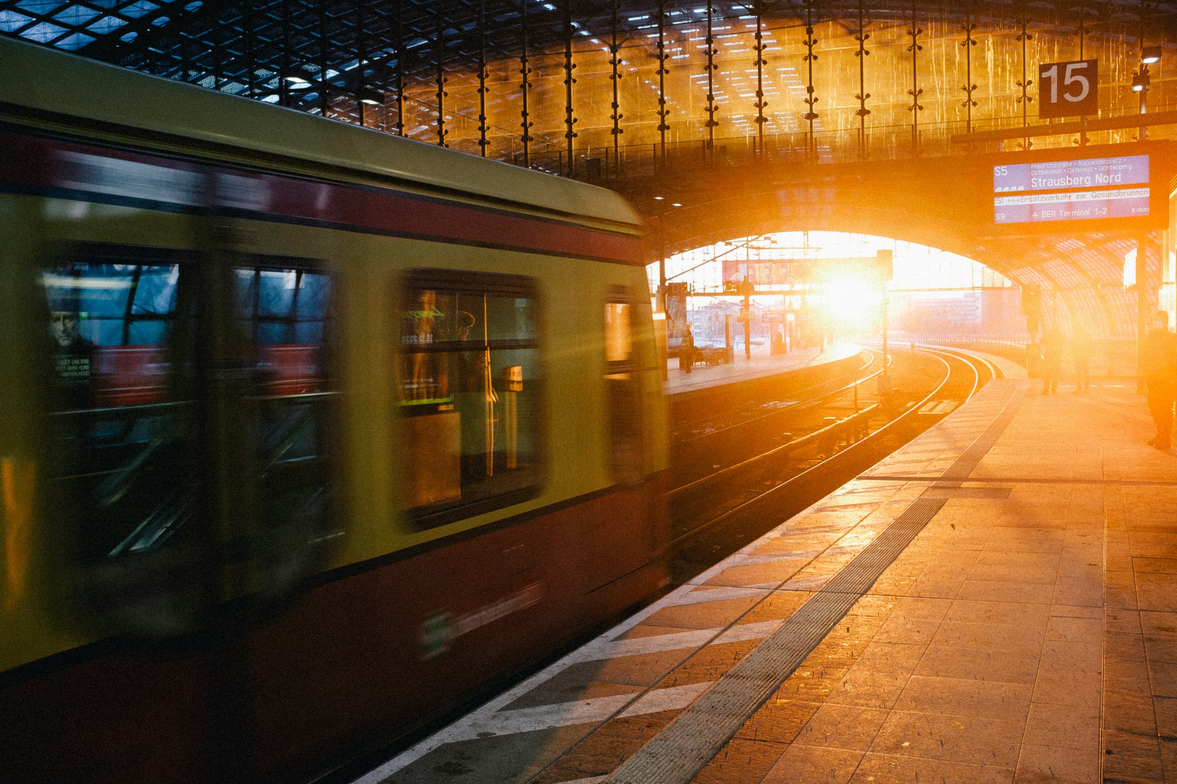 Train arriving at a station bathed in golden light